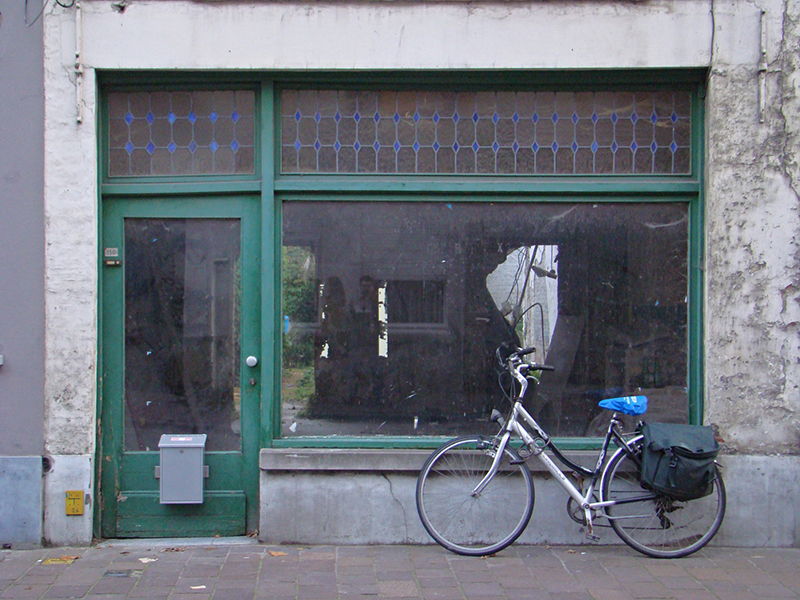 An old bike in front of an old store